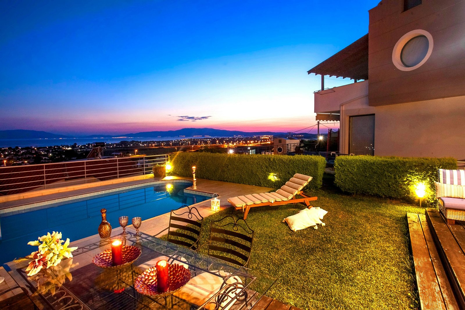 Experience a tranquil sunset by the pool with stunning views in Greece.