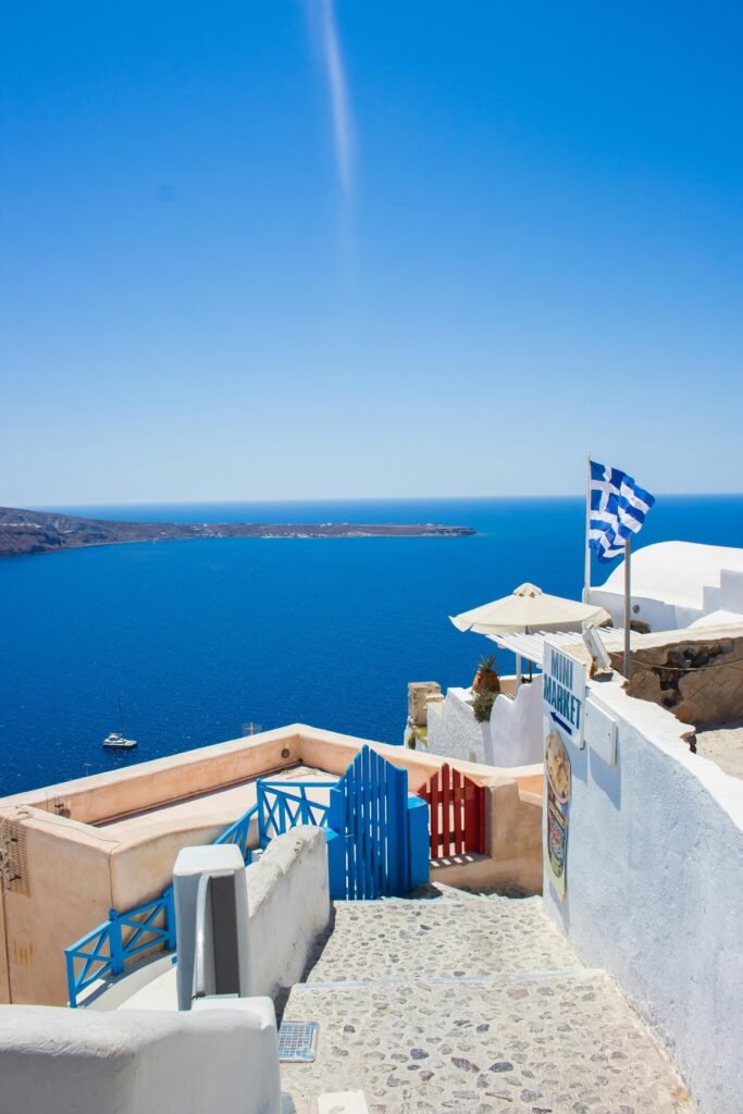 Explore the stunning blue Aegean Sea view from Santorini with Greek architecture and vibrant skies.