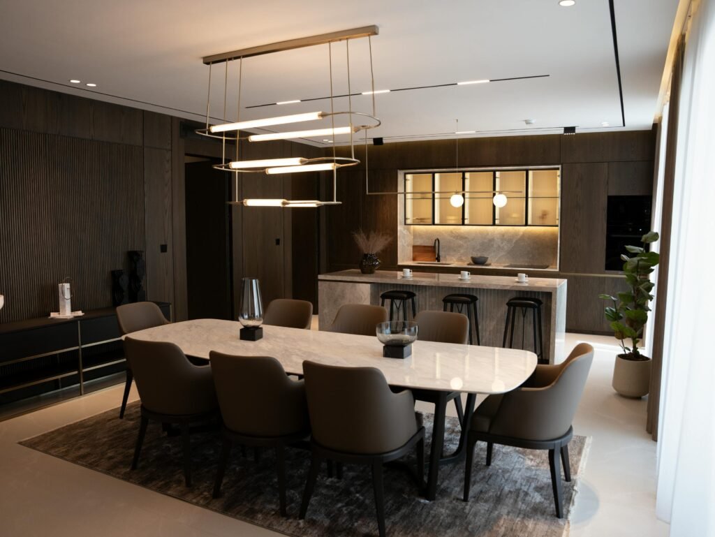 Luxurious contemporary dining room with a marble table and chic lighting fixtures.